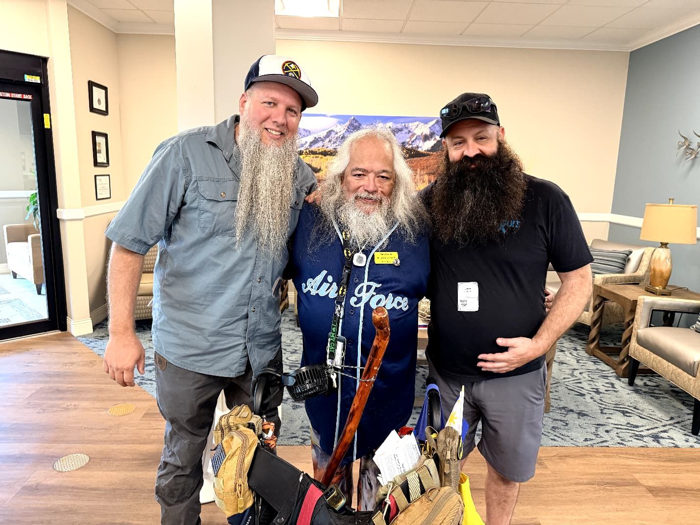 Three WarriorNOW veterans arm in arm at a community gathering